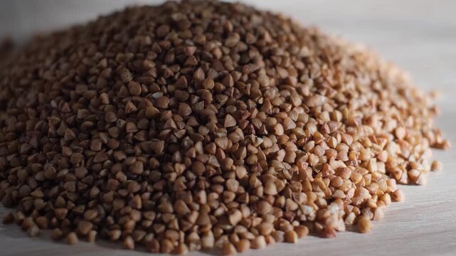 A pile of selected buckwheat groats on the table, close-up
