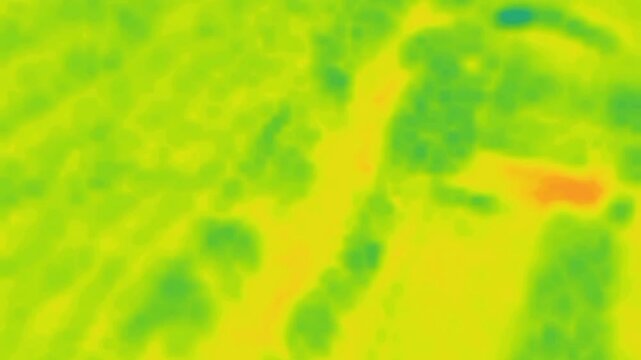 Dynamic background of green, red and orange expanding spots. Image from thermal imager device.
