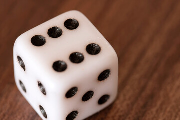 Close up view of old dice with black dots placed on wooden surface. Symbolizing chance, luck, probability, risk and board game concepts with shallow depth of field. Selective focus.