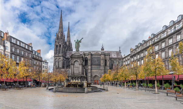 Clermont-Ferrand, France - 10 24 2025: Panoramic view of the Cathedral of Our Lady of the Assumption building, Place de la Victoire and Urban II Fountain in front with autumn color