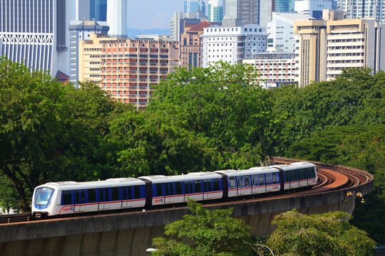 KUALA LUMPUR, MALAYSIA - MARCH 17, 2024: Rapid KL LRT public transportation train on elevated track in downtown Kuala Lumpur city.