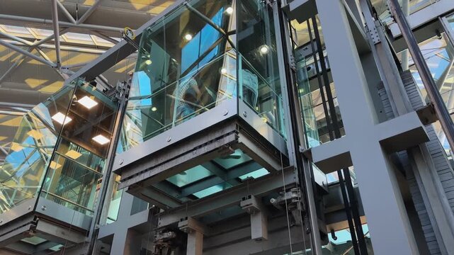 Tourist people using contemporary glass elevator inside international airport in Cologne, Bonn in Gemany