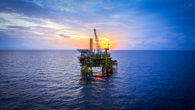 sunset over the oil and gas platform