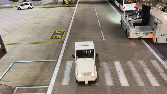 Service vehicle drive on international airport in Cologne Bonn at night in Germany