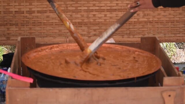 The process of making Jenang or durian dodol, a traditional Indonesian snack that is chewy and soft in texture, is made from a mixture of durian flesh, coconut milk, glutinous rice flour, and sugar.