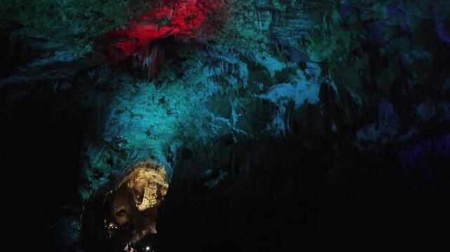 Explore Prometheus Cave with bright colors shining on natural rocks and formations