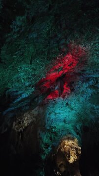 Explore Prometheus Cave with bright colors shining on natural rocks and formations