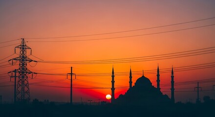 Silhouette of mosque with minarets and power lines at sunset.