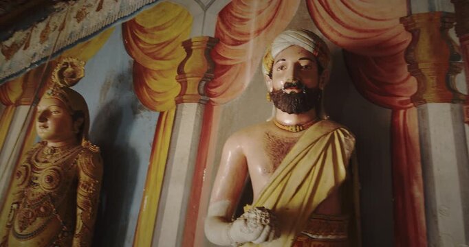 Elegant Statues Surrounded by Stunning Temple Mural Works