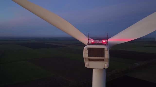 Wind farm at sunrise or sunset. Aerial night view of Windpark with wind turbines. Windmill for electricity production. Power plant, climate change, sustainable resources, green renewable energy. 4K