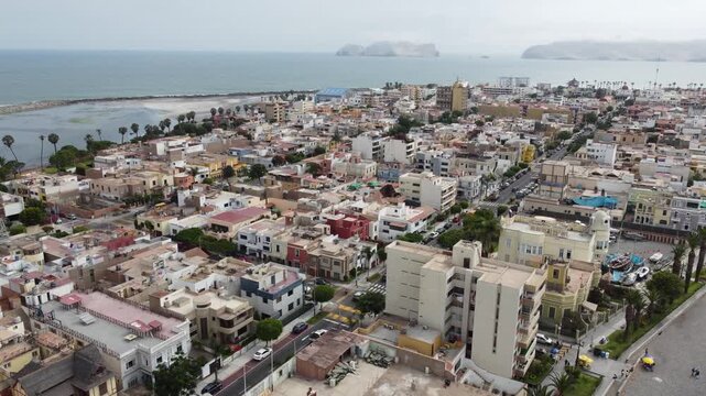 aerial view callao coastline colorful rooftops bustling harbor islands in distance. dense lowrise