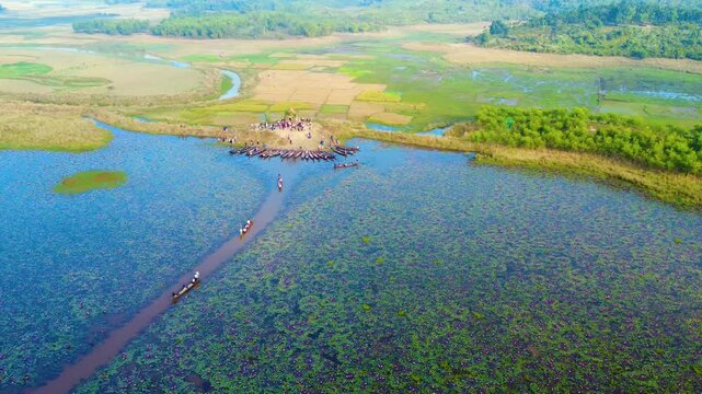 Drone top view of a row of boats on the Dibir Lake a beautiful and famous tourist spot located at the foot of the Meghalaya hills in Jaintapur, Sylhet, near the Bangladesh-India border.