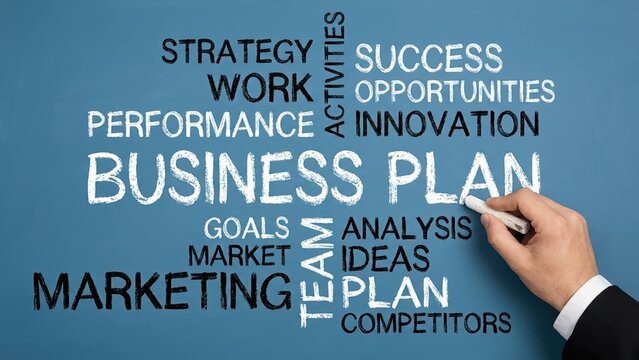 Business plan concepts written in chalk on a blue board illustrating teamwork and marketing success strategies.