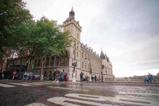 Low angle view of a historic riverside building and wet street