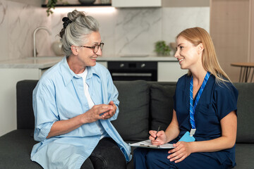 Senior woman meets with healthcare professional for consultation at home
