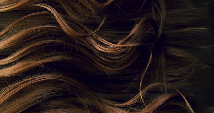 Ultra slow motion shot of dark brown hair flowing in smooth, elegant waves, forming natural curves and motion. Captured at 1000 fps, revealing fine texture, shine, and fluid cinematic movement.