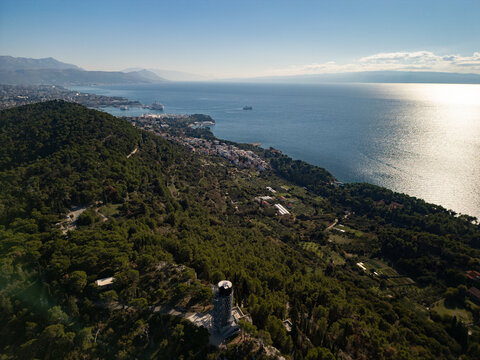 Epic forest park tower panorama. 
Cinematic aerial drone view 
of Marjan hill observatory 
and Split cityscape in 
Croatia. 4K nature landscape.

