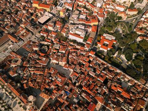 Split Croatia old town historic city skyline panorama with orange tiled roofs aerial drone view.
