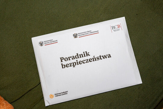 Warsaw, Poland - Jan 29, 2026: A prominent safety guide, titled Poradnik bezpieczeństwa, placed on a textured surface, highlighting its significance in public safety and emergency preparedness.
