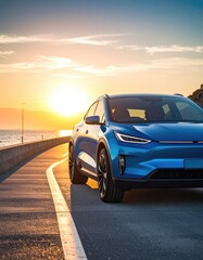 A vibrant blue crossover SUV drives along a sunlit coastal road at sunset.