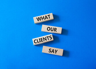 Clients symbol. Concept words What our Clients Say on wooden blocks. Beautiful bright blue background. Business and What our Clients Say concept. Copy space.