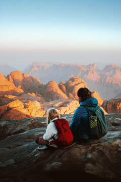 Family camping trip father and daughter hiking in mountains travel vacations weekend outdoor dad with child backpacking together active lifestyle adventure trip parent and kid enjoying views in Egypt
