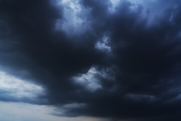 Obraz premium Dark Clouds rain storm and sun beam in storm. Dramatic sky background