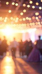 An abstract representation of a warmly lit indoor event with bokeh lights.
