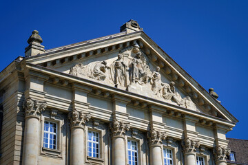 Obraz premium Detailed low angle shot of the neo-baroque stone reliefs and ornate columns at the Higher Regional Court on Reichenspergerplatz, Cologne
