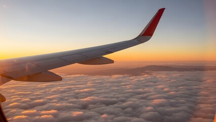 Obraz premium Airplane wing soaring through clouds during a breathtaking sunset