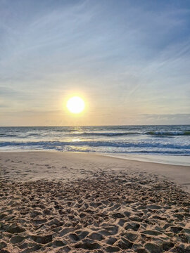 Peaceful Beach at Sunrise with Soft Golden Light
