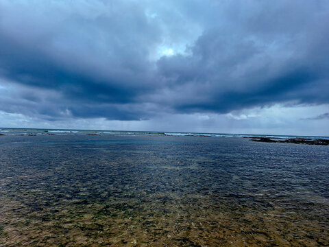 Dramatic Storm Clouds Over Shallow Ocean