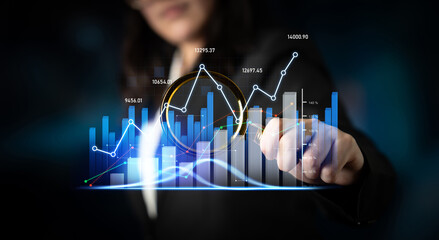 A business professional conducts a thorough analysis of financial data using a magnifying glass,...