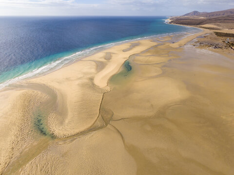 Aerial view of the coast's golden sands meeting the turquoise ocean by the peninsula and lagoon of Jandia, Jand&Atilde;&shy;a Natural Park, Fuerteventura, Canary Islands, Spain.