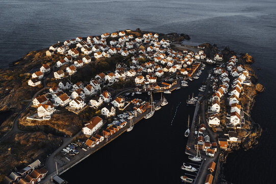 Aerial view of the charming &Atilde;&hellip;stol island, where red-roofed houses nestle against the rugged coastline, framing a serene harbor dotted with boats, &Atilde;&hellip;stol, V&Atilde;&curren;stra G&Atilde;&para;taland County, Sweden.