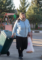 woman collects trash from a children's party.