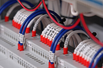 Marking electrical wiring wires with thermally printed nylon tape. 