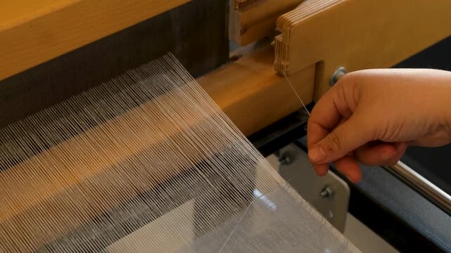 Artisan Hands Organizing Threads on Traditional Weaving Loom - 4K Macro