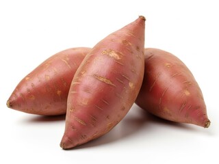 Three whole raw red sweet potatoes on a white background