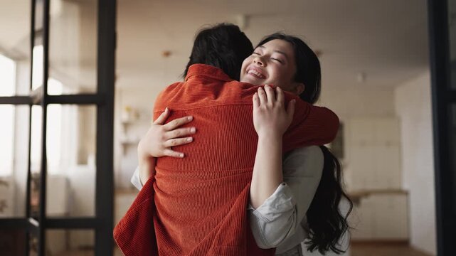 Happy Korean man showing apartment key to girlfriend after home purchase