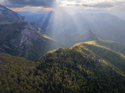 Aerial view of the majestic mountains, where sunbeams penetrate the misty valleys and illuminate the lush greenery, Tjenti&Aring;&iexcl;te, Republika Srpska, Bosnia and Herzegovina.