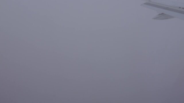 Paris, France A plane lands at Charles De Gaulle Airport in the heavy fog. 