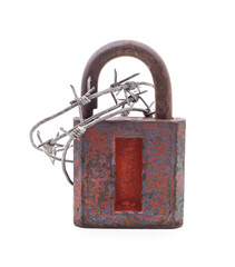 Old padlock wrapped in barbed wire.