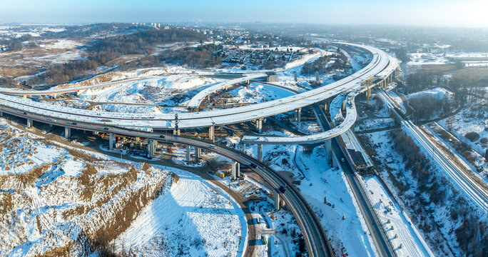 Krakow, Poland. Mistrzejowice highway interchange under construction. Temporary ramps joining S52 and S7 from Warszawa. Eastern part of beltway around Cracow. Aerial panorama in winter. January 2026