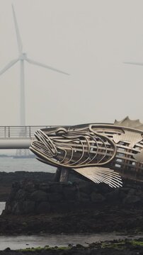 Jeju Island, Jeju-Do, South Korea,  Sinchang Windmill Coastal Road landscape, line of wind mills power generators along the coast, offshore wind farm energy turbines, aerial drone view, green energy