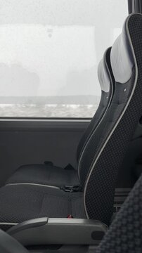 Intercity bus interior with empty passenger seats by window, winter road travel, public transport, sustainable mobility, eco travel concept.