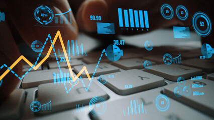 Naklejka premium A focused scene of hands typing on a keyboard surrounded by dynamic data visualizations, showcasing analytics and trends essential for business performance evaluation. Xenic