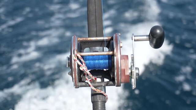 Trolling rod reel, fish caught on a hook, trolling fishing in the sea