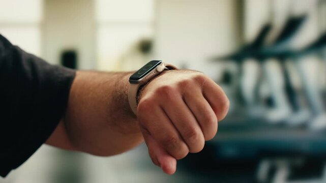 Smart watch using in gym, Close up of woman hands im gym checking incoming notification on smart watch. Incoming text message received on app smartwatch. Social media networking technology concept.