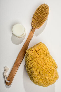 Overhead of bath scrubber, loofah and white soap